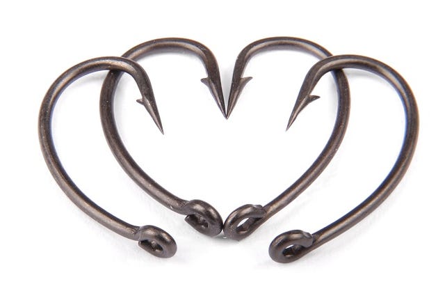 Four fishhook drawn up in heart shaped isolated on white backround.